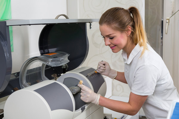 Dental assistant using CEREC technology.